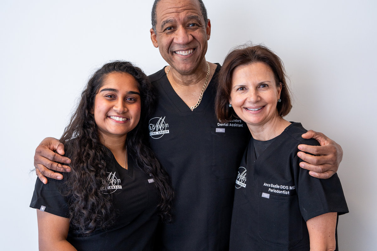 The Madison Dental Group dentists and staff standing together in their Midtown Manhattan office.